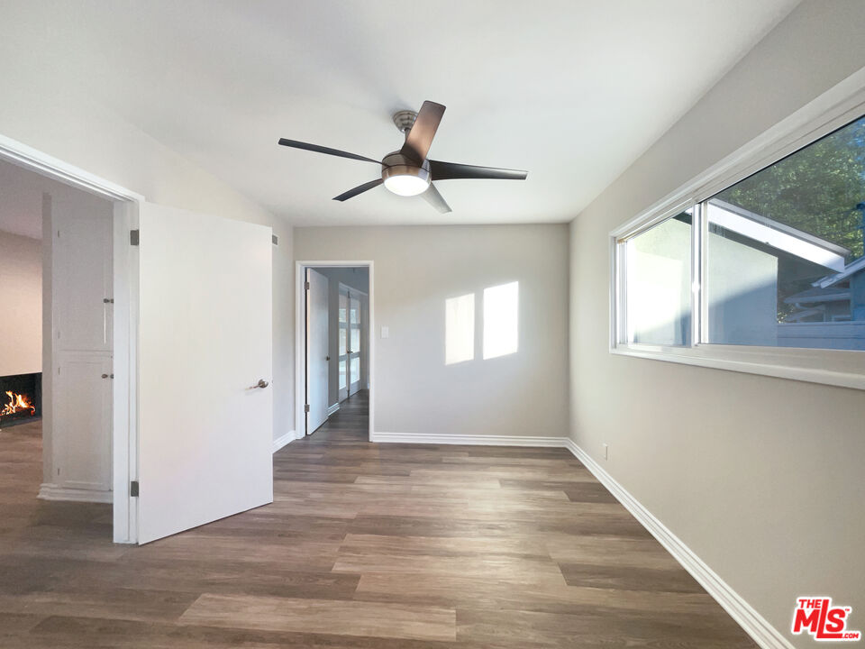 7944 Limerick Avenue Winnetka, CA 91306 - Photo 17 of 23 a view of an empty room with window and wooden floor