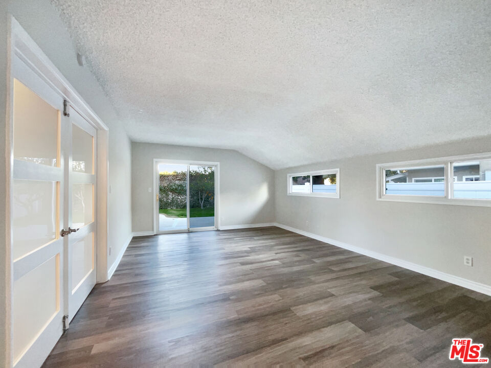7944 Limerick Avenue Winnetka, CA 91306 - Photo 19 of 23 a view of an empty room with wooden floor and a window