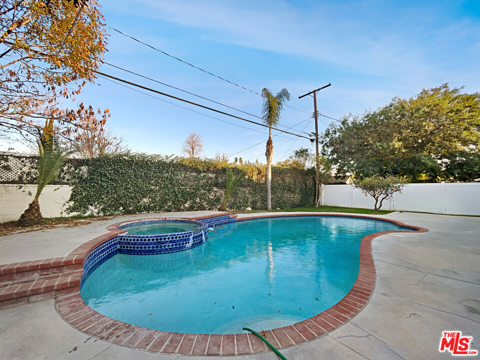 7944 Limerick Avenue Winnetka, CA 91306 - Photo 21 of 23 a view of a swimming pool with a yard