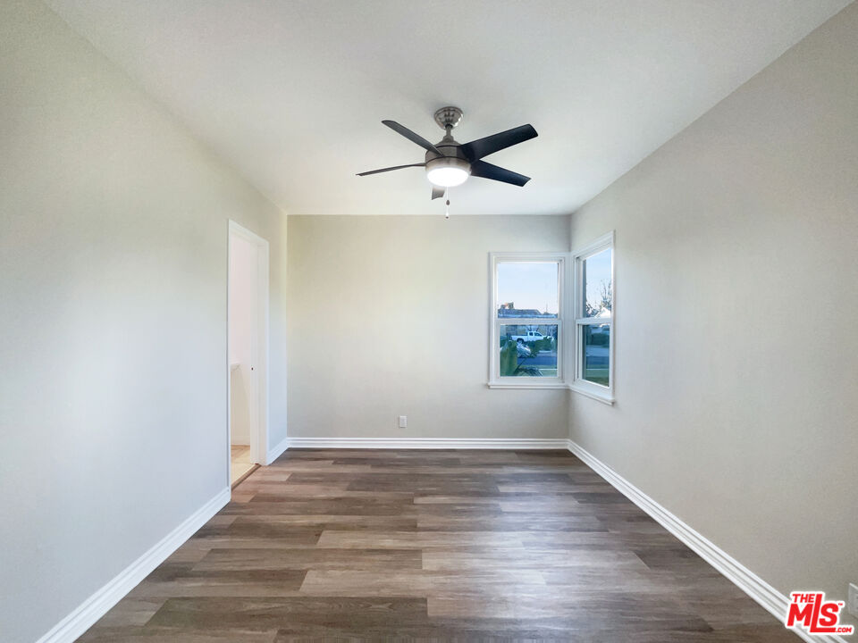 7944 Limerick Avenue Winnetka, CA 91306 - Photo 5 of 23 a view of empty room with wooden floor and fan