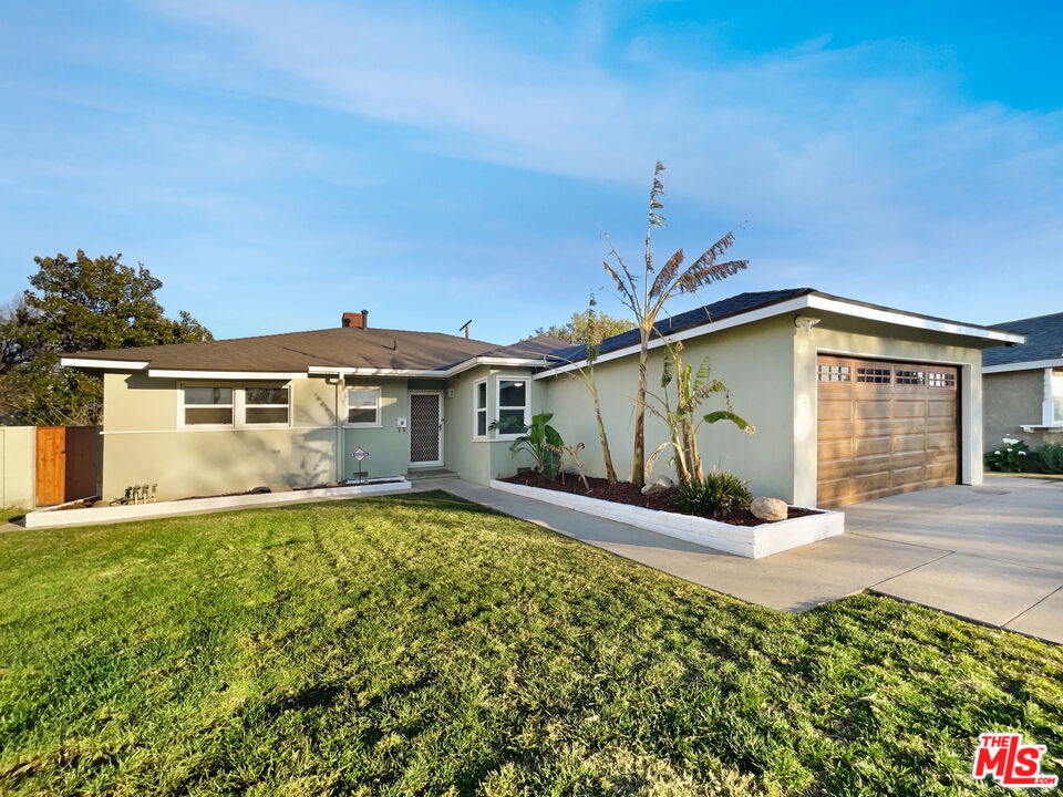 7944 Limerick Avenue Winnetka, CA 91306 - Photo 7 of 23 a front view of a house with a yard