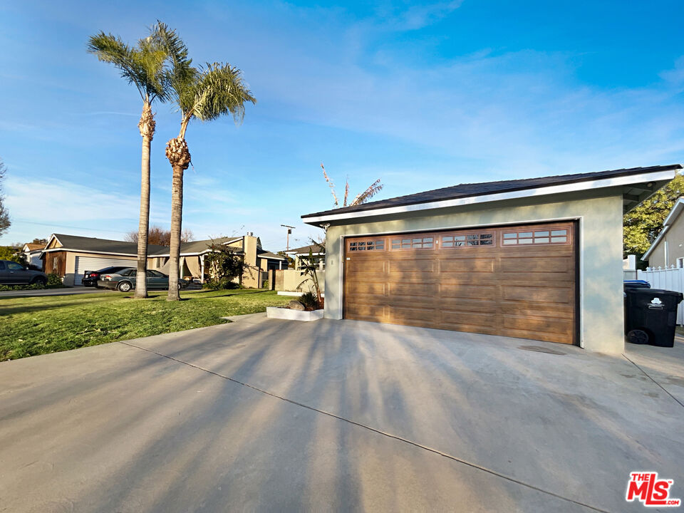 7944 Limerick Avenue Winnetka, CA 91306 - Photo 8 of 23 a view of a house with a yard and garage