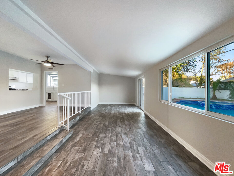 7944 Limerick Avenue Winnetka, CA 91306 - Photo 10 of 23 an empty room with wooden floor and windows
