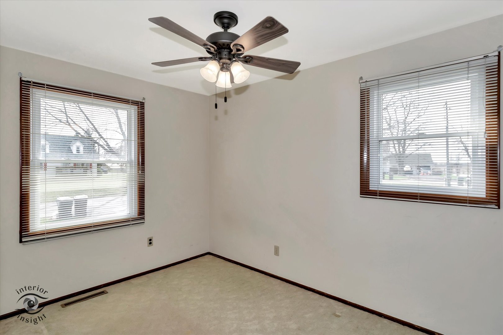 589 South Walnut Street Chebanse, IL 60922 - Photo 12 of 25 an empty room with windows and fan