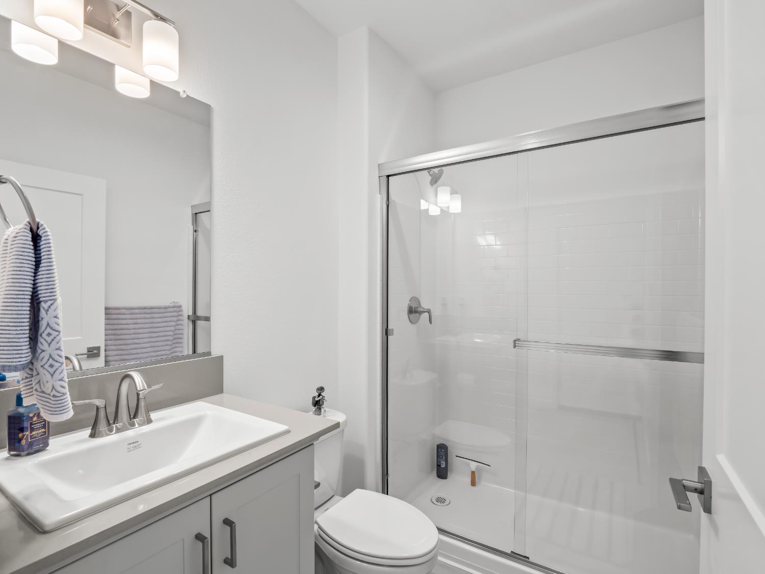 4071 Braden Road Madera, CA 93636 - Photo 12 of 31 a bathroom with a sink mirror toilet and shower