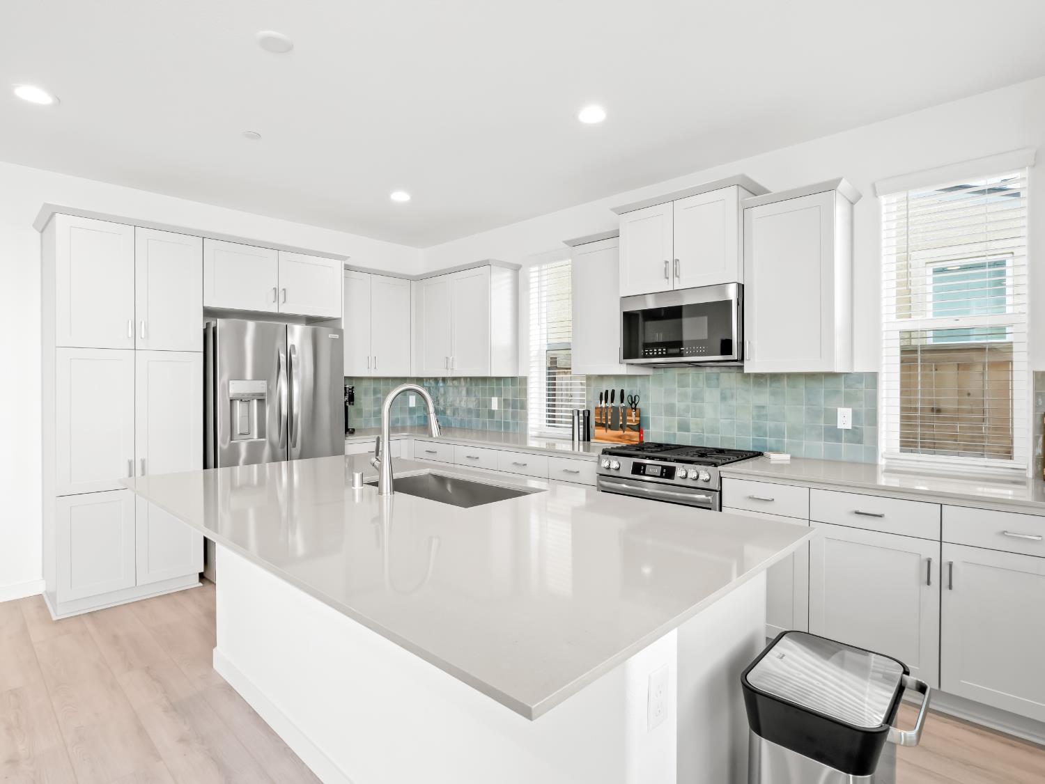 4071 Braden Road Madera, CA 93636 - Photo 13 of 31 a large kitchen with a refrigerator a stove a sink a dining table and chairs
