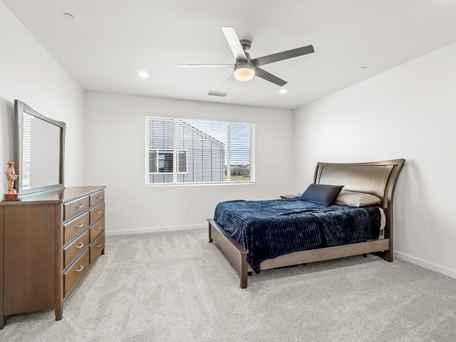 4071 Braden Road Madera, CA 93636 - Photo 18 of 31 a spacious bedroom with a bed and a dresser