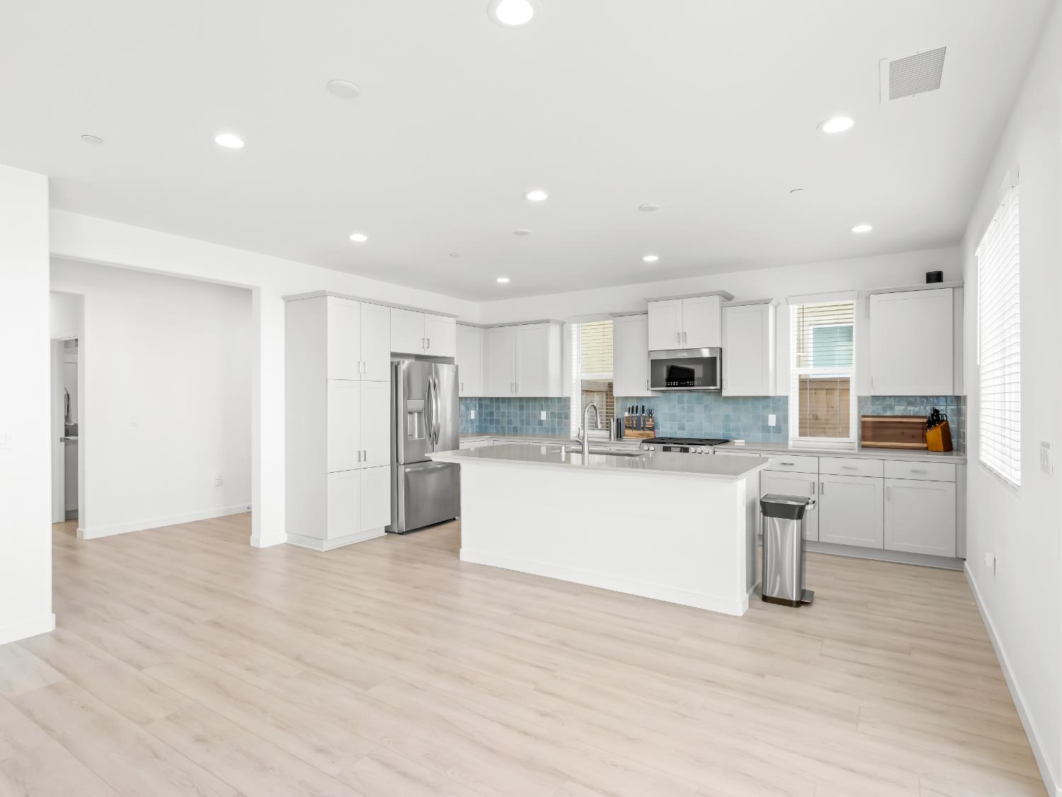 4071 Braden Road Madera, CA 93636 - Photo 8 of 31 a large white kitchen with stainless steel appliances granite countertop a large counter top and a wooden floors