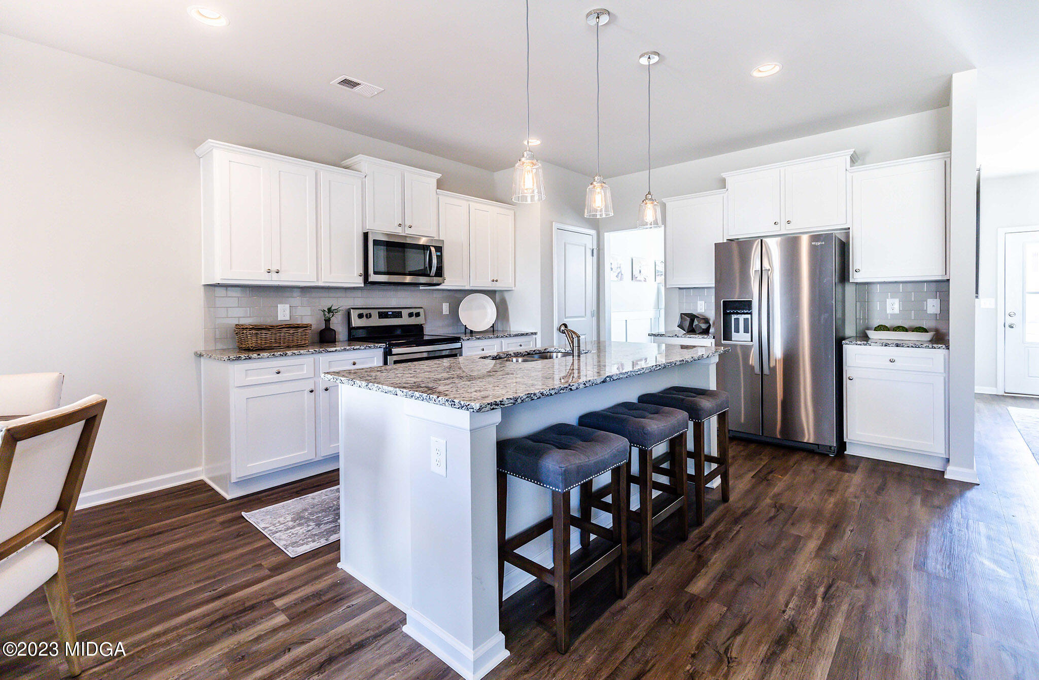 118 Red Birch Lane Warner Robins, GA 31093 - Photo 8 of 19 a kitchen with stainless steel appliances granite countertop a refrigerator a stove a sink and a microwave