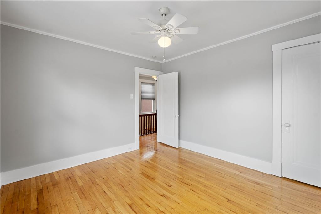 86 Duncan Avenue Pittsburgh, PA 15205 - Photo 18 of 30 an empty room with wooden floor and ceiling fan