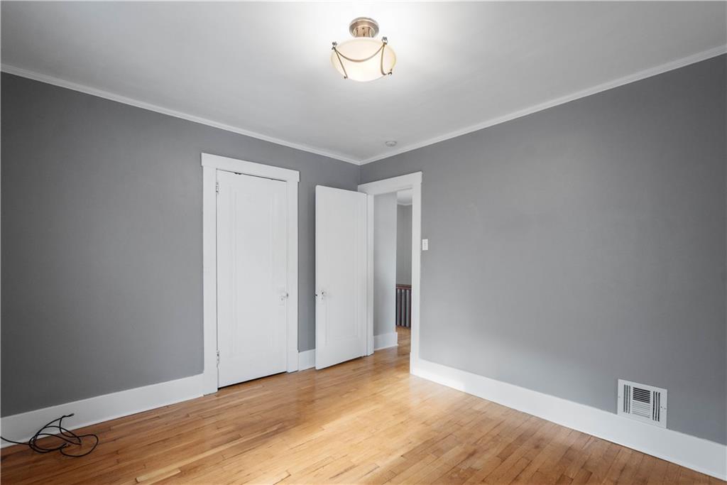 86 Duncan Avenue Pittsburgh, PA 15205 - Photo 21 of 30 a view of an empty room with wooden floor and a window