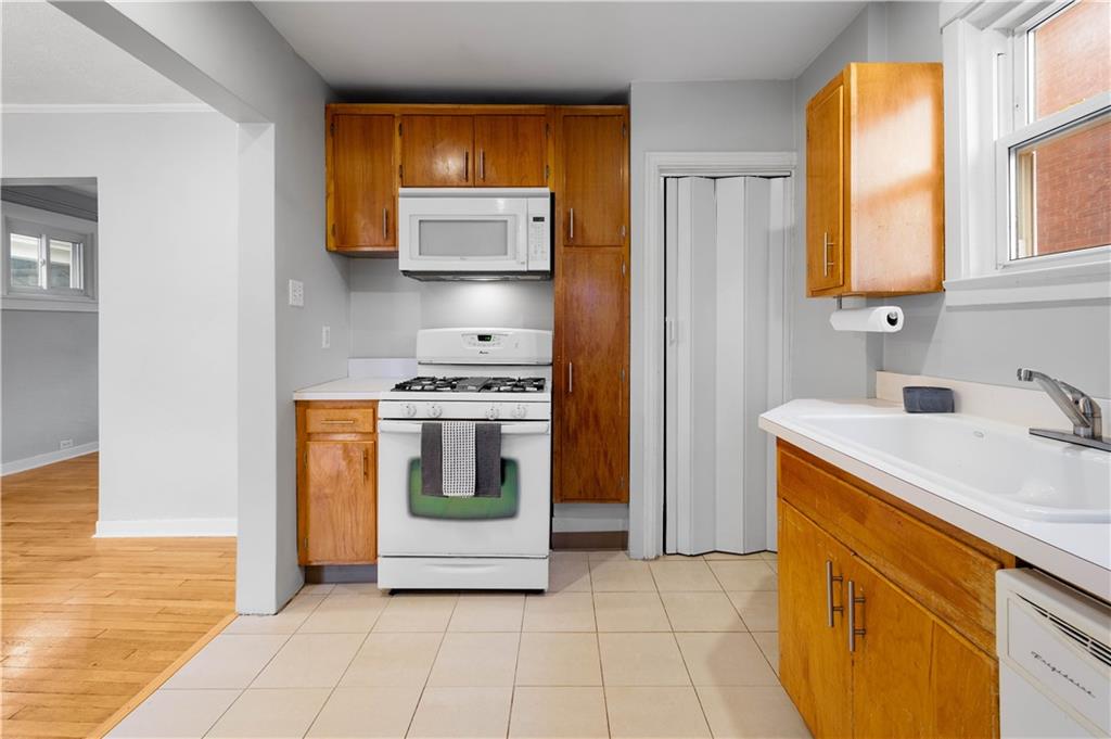 86 Duncan Avenue Pittsburgh, PA 15205 - Photo 10 of 30 a kitchen with a stove a sink and a refrigerator