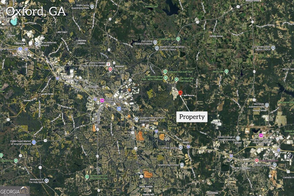 0 Cook Road, Unit LOT 26 Oxford, GA 30054 - Photo 11 of 11 a sign that is sitting in front of a tree