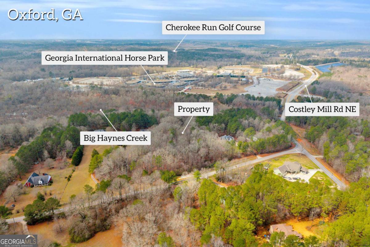 0 Cook Road, Unit LOT 26 Oxford, GA 30054 - Photo 2 of 11 a sign broad on the side of the road