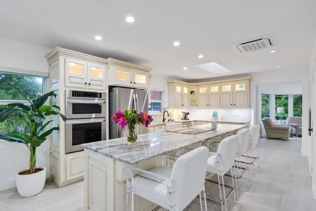a kitchen with sink a microwave and cabinets