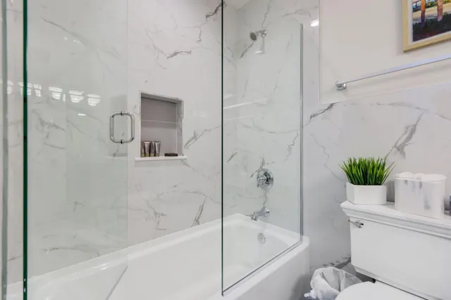 a bathroom with a bathtub and a shower
