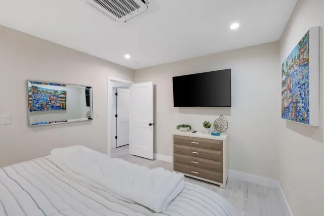a bedroom with a bed and a flat screen tv
