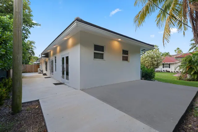 a view of a pathway with a flower garden