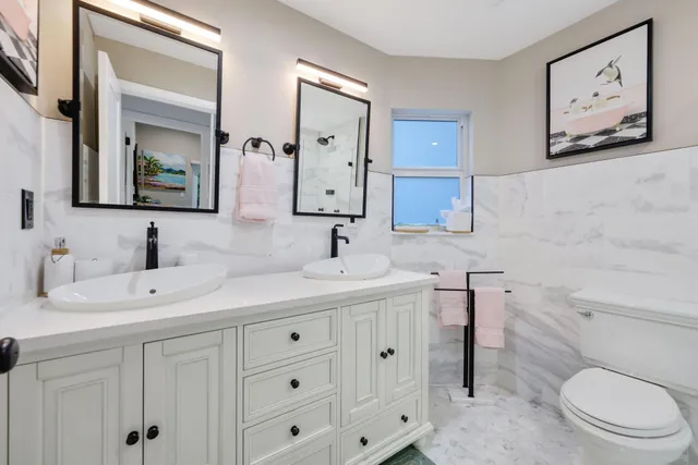 a bathroom with a toilet sink and mirror