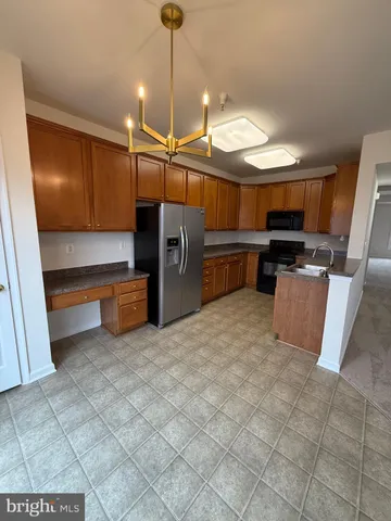 a open kitchen with cabinets and a wooden floor