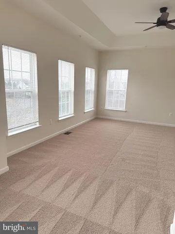 a spacious bathroom with a bathtub sink and mirror