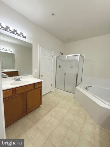 a bathroom with a tub sink and mirror