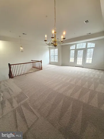 a view of a livingroom with a chandelier fan