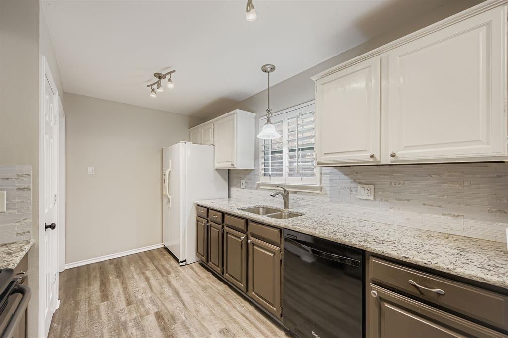 5416 Catlow Valley Road Fort Worth, TX 76137 - Photo 14 of 28 a kitchen with stainless steel appliances granite countertop a sink a stove and a refrigerator