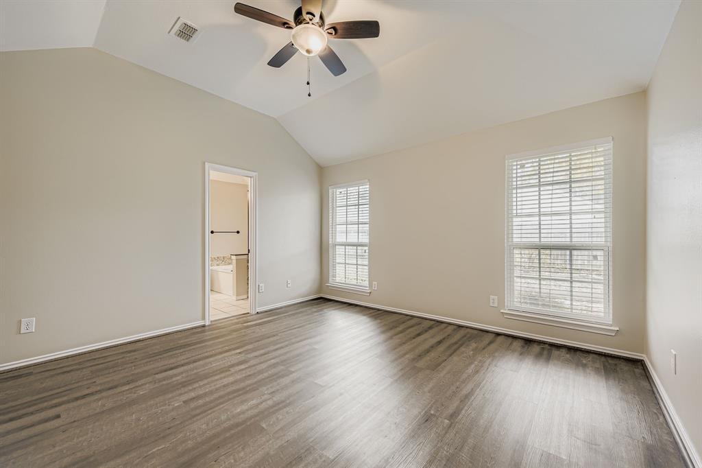 5416 Catlow Valley Road Fort Worth, TX 76137 - Photo 17 of 28 an empty room with wooden floor fan and windows
