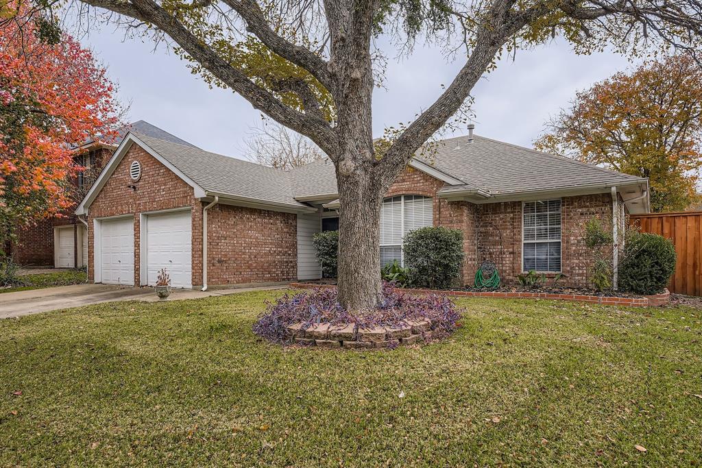 5416 Catlow Valley Road Fort Worth, TX 76137 - Photo 2 of 28 a front view of a house with a garden and yard