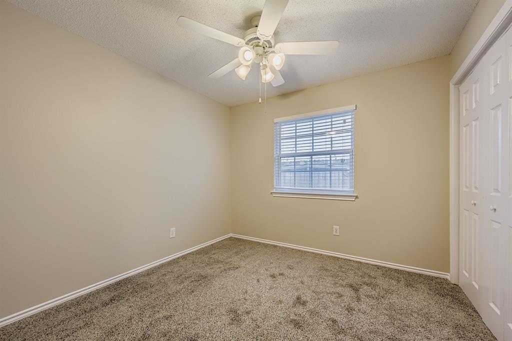 5416 Catlow Valley Road Fort Worth, TX 76137 - Photo 22 of 28 an empty room with windows and ceiling fan