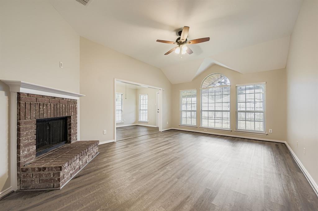 5416 Catlow Valley Road Fort Worth, TX 76137 - Photo 5 of 28 a view of an empty room with wooden floor fireplace and a window