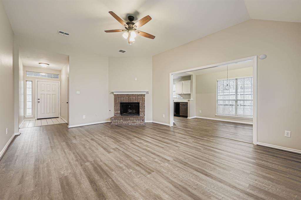 5416 Catlow Valley Road Fort Worth, TX 76137 - Photo 6 of 28 a view of an empty room with wooden floor and a window