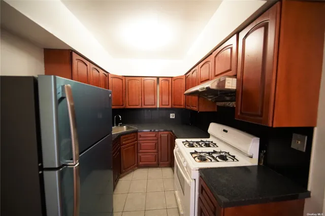 a kitchen with stainless steel appliances a stove a refrigerator and a sink