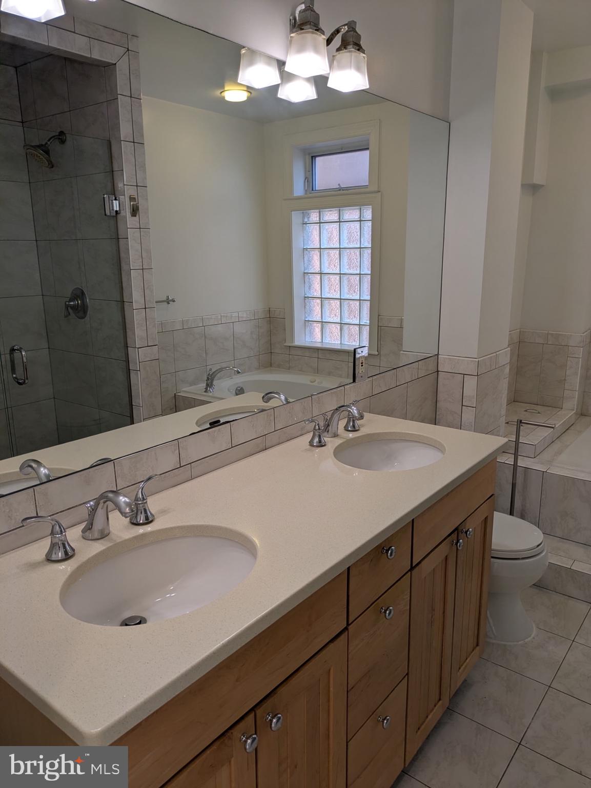 1421 Q Street Northwest, Unit 1 Washington, DC 20009 - Photo 13 of 19 a bathroom with a sink double vanity and a mirror