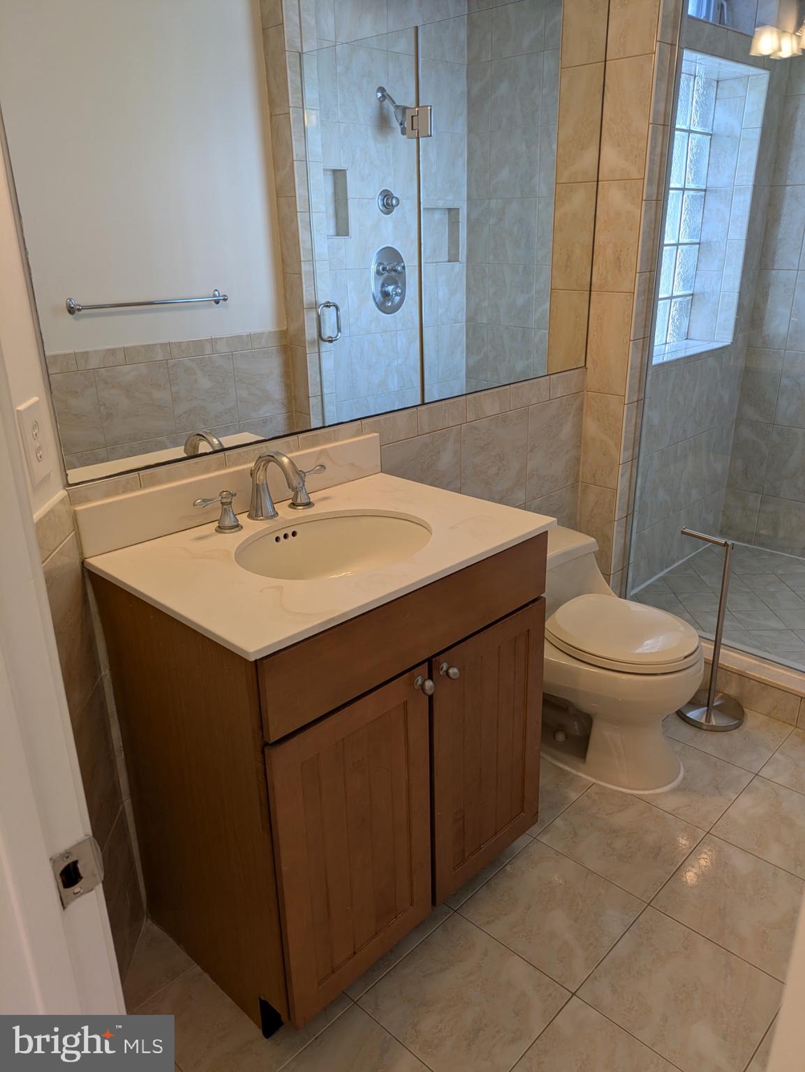 1421 Q Street Northwest, Unit 1 Washington, DC 20009 - Photo 17 of 19 a bathroom with a sink toilet and mirror