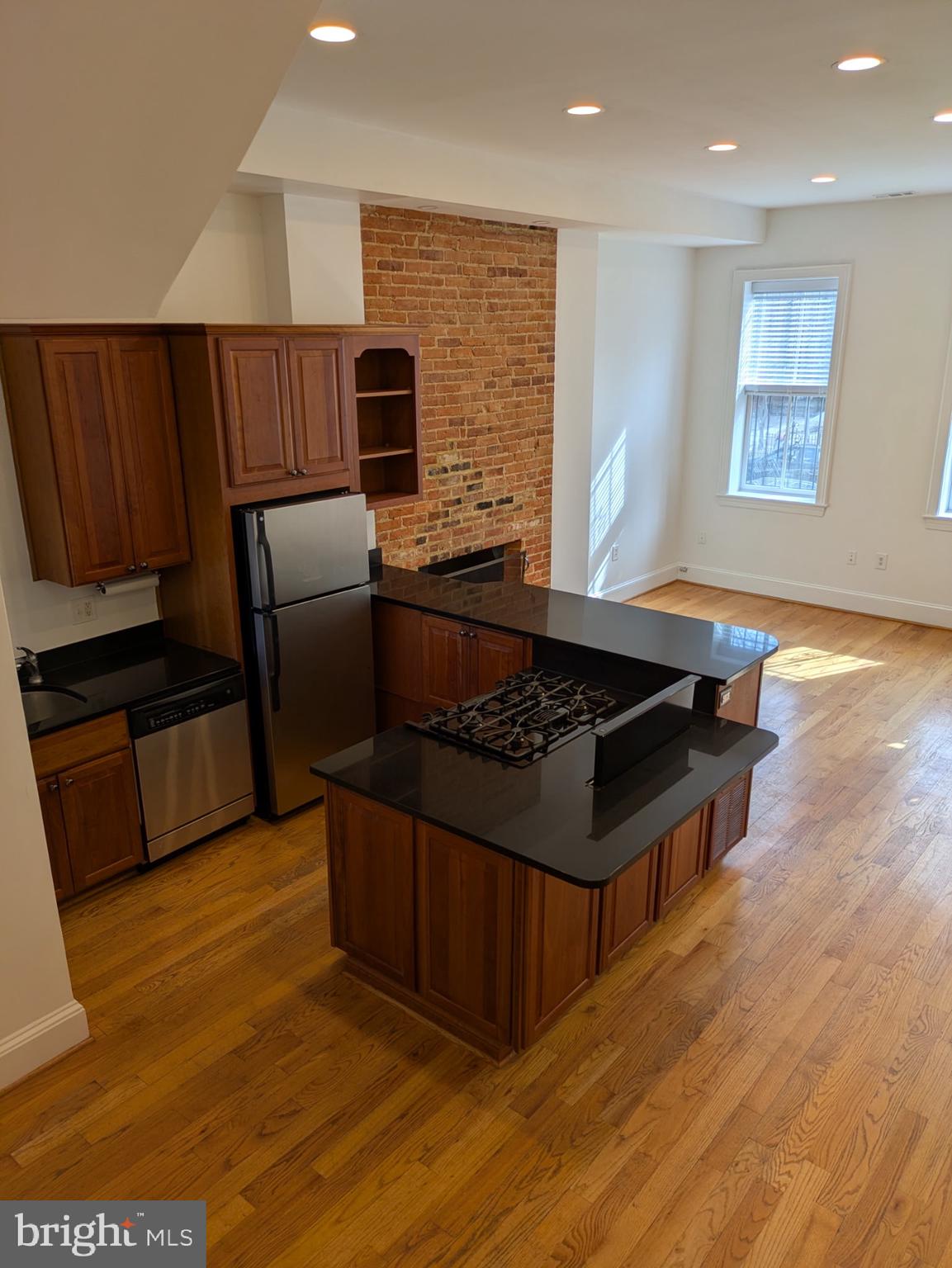 1421 Q Street Northwest, Unit 1 Washington, DC 20009 - Photo 5 of 19 a kitchen with stainless steel appliances granite countertop a stove and a refrigerator
