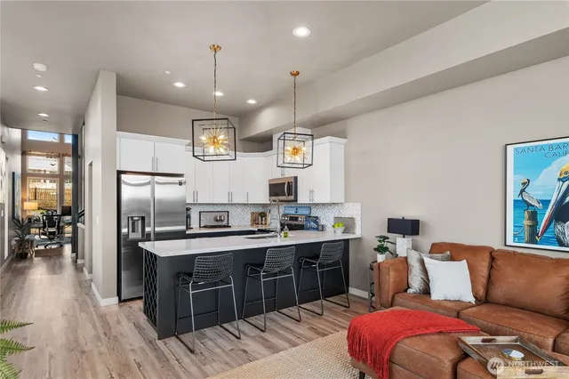 a view of kitchen with stainless steel appliances granite countertop lots of counter top space