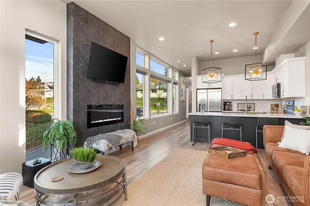 a living room with furniture a flat screen tv and a fireplace