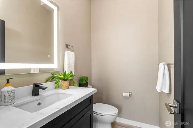 a bathroom with a sink toilet and mirror