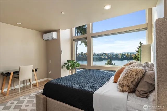 a living room with a bed furniture and a large window