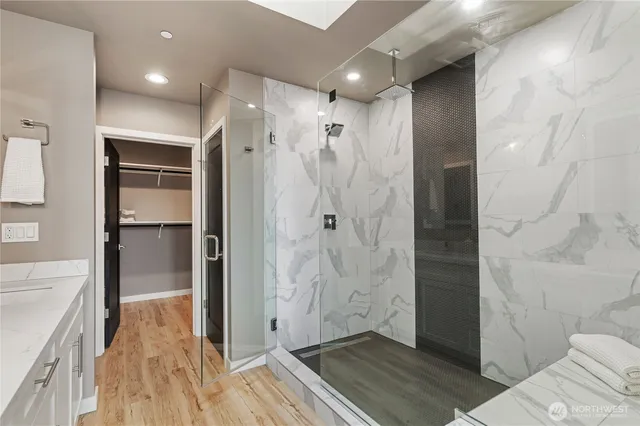 a bathroom with a shower and a glass door