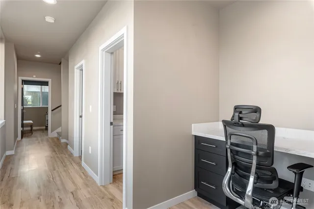 a view of a room with wooden floor