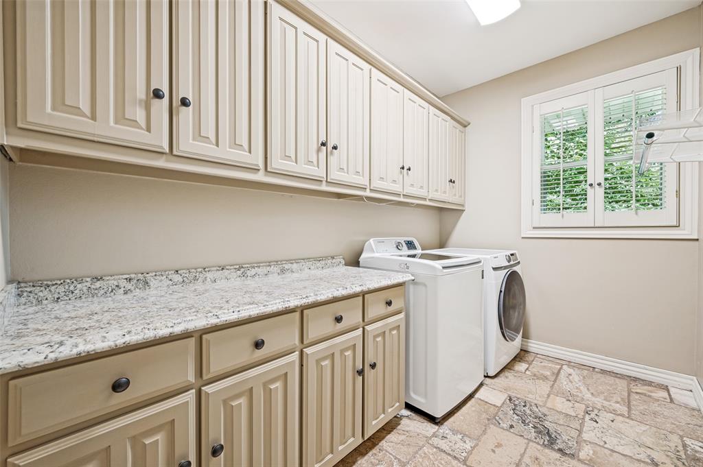 9 Country Ridge Road Melissa, TX 75454 - Photo 26 of 37 Lots of cabinets, granite counter for folding clothes, a hanging spot and an ironing board that folds into the wall!