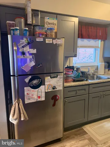 a kitchen with stainless steel appliances granite countertop a refrigerator and a stove