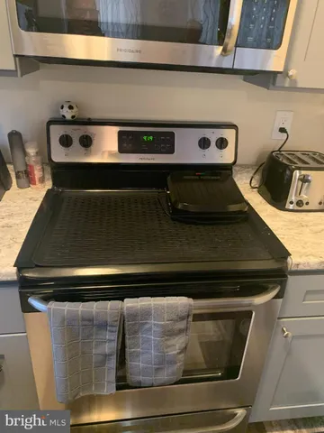 a kitchen with a stove and a cabinet