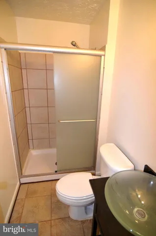 a bathroom with a toilet and a shower