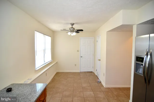 a view of an empty room with a fireplace