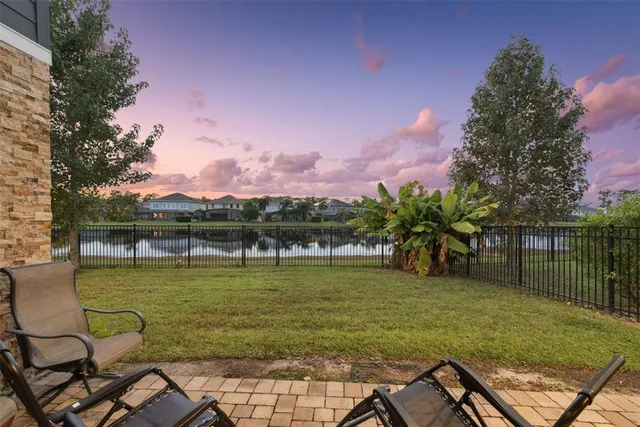 a view of a patio with table and chairs and potted plants