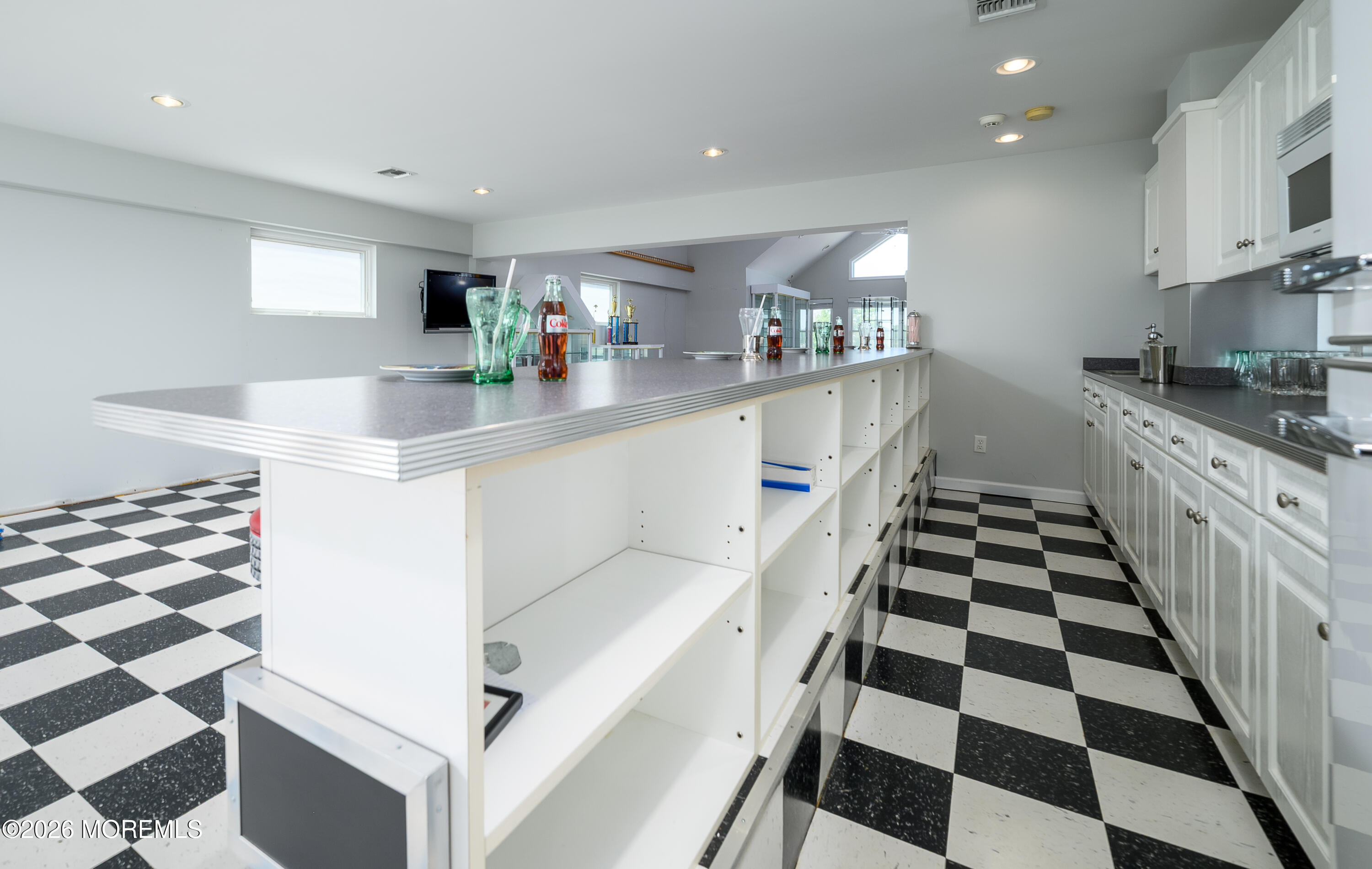805 Front Street Union Beach, NJ 07735 - Photo 32 of 65 a kitchen with granite countertop a sink and a black white checkered floor